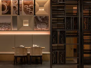 A minimalist restaurant interior with wooden, metal, and glass elements