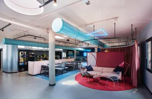 A modern cafe bar with metal, fabric, and wood elements.