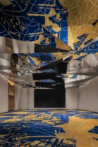 Interior view of a modern conference room with metallic texture ceiling and floor patterns.