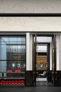 Modern industrial lobby featuring metal, wood, and glass materials.