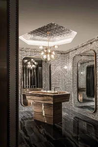 Contemporary marble bathroom with geometric tiles and elegant chandelier.