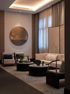 A modern living room with neutral tones and minimalist design.
