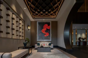 A modern hotel lobby with marble and concrete finishes, showcasing contemporary design elements.