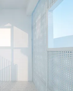 A minimalist interior with a metallic grid wall and natural light.