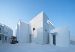 Modern building with white architecture and concrete elements.