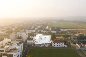 Aerial view of a village with modern architecture painted in white.