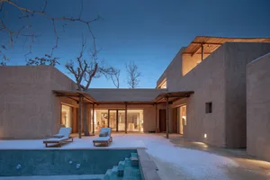 Modern residential exterior with concrete and wood materials.