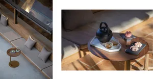 Modern interior design featuring a comfortable sofa adorned with plush cushions and a wooden coffee table.