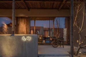A modern residential exterior featuring concrete materials and minimalist design elements.