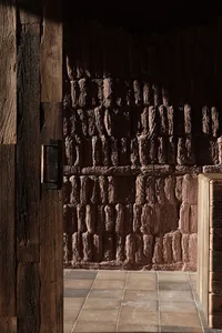 A wooden panel wall next to a clay brick textured wall in an interior space.