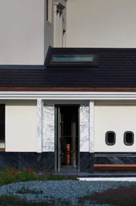 Modern minimalist building entrance featuring marble materials.