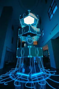 A futuristic industrial installation featuring aluminum, glass, and neon lights.