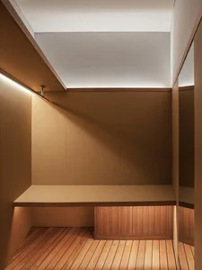 Minimalist closet with wooden floor, showing clean lines and natural materials.