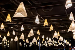 Hanging paper lamps in a minimalist restaurant interior design.