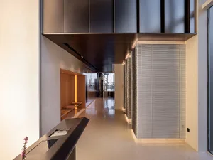 Modern commercial entryway featuring metallic texture and minimalist design elements.