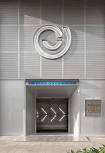 Modern entrance with metallic design elements and illuminated pathway.