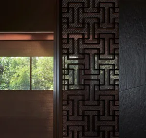 Close-up of a modern interior wall featuring a metallic geometric pattern.