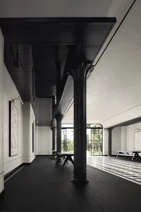 Modern interior design featuring a corridor with black wooden floors and ceiling, arches, and white walls with framed artwork