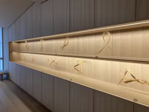An interior design featuring a wooden art installation with intricate designs on shelves.