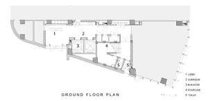 A detailed 2D architectural drawing depicting the layout of a building's ground floor, including a lobby, corridor, elevator,