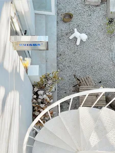 White spiral staircase and terrace with minimalist design elements.