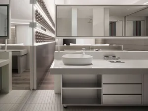 Modern bathroom designed with white ceramic tiles and minimalist fixtures.