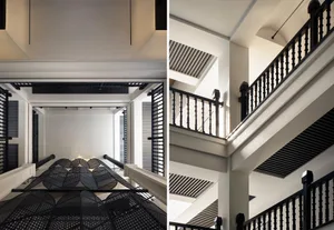 Modern, minimalist staircase with black metal railings and a geometric design.