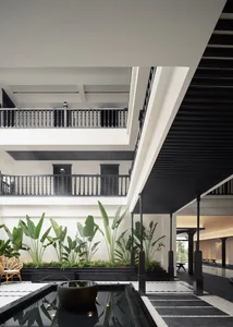 Interior view of a modern hotel lobby featuring contemporary architecture with concrete and wooden materials.