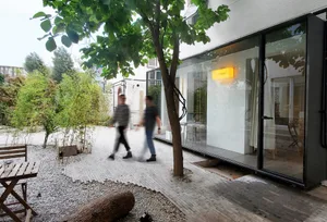 A modern interior design featuring glass walls