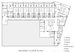Floor plan of a commercial building on the second floor with various rooms and areas labeled, including staircases, elevators