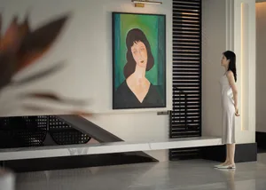 A minimalist modern living room featuring a woman with brown hair dressed in green standing in front of a painting of a woman