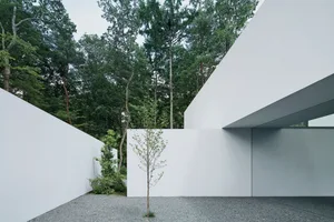 A minimalist indoor space featuring concrete and glass