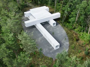 A modern architectural pavilion constructed from concrete.