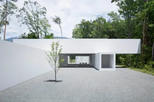 A modern exterior platform made of concrete with trees and mountains in the background.