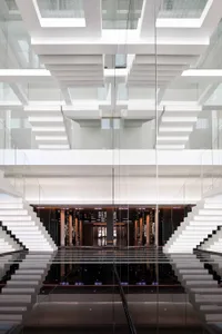 The interior design features contemporary, minimalist aesthetics with extensive use of transparent glass.