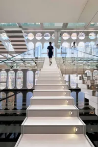 A modern interior space featuring white glass walls and sustainable design elements.