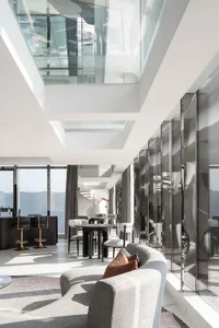 A modern living room featuring transparent glass ceilings.