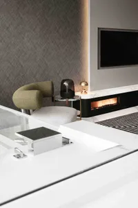 Modern minimalist living room with sleek furniture, a fireplace, and textured walls.