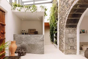 A modern living space featuring stone, concrete, and wood elements.