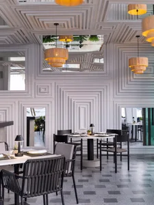 A modern restaurant featuring geometric concrete structures and minimalist design.
