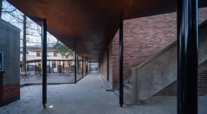 Industrial-styled courtyard with brick walls, concrete floors, and metal railings
