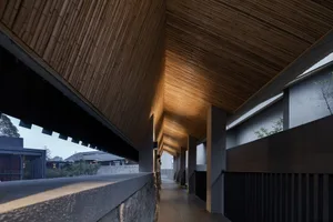 Modern minimalist residential interior with wooden ceiling and floor.