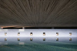 Modern spa interior with a bamboo ceiling, tiled floor, and minimalist design.