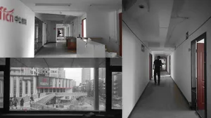 An interior corridor with concrete floor tiles.