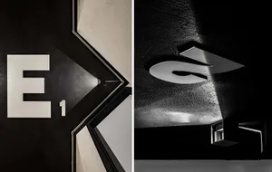 Modern entranceway featuring a minimalist design with polished metal signage and sleek, industrial-style finishes.