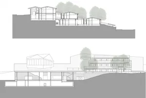 A modern house with a glass balcony overlooking a hillside.