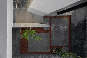 A modern interior space with concrete flooring and wooden stairs adjacent to a patio covered in dark soil with a single plant