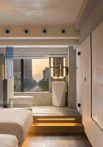 Modern minimalist residential interior with cityscape view and contemporary design elements.