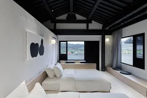 Modern bedroom with white furniture and minimalist decor.