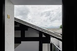 A residential building with a terrazzo roof visible through an open doorway.